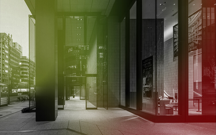 This photo captures the entrance area of Museum Tower Kyobashi with a gradation from green to red.